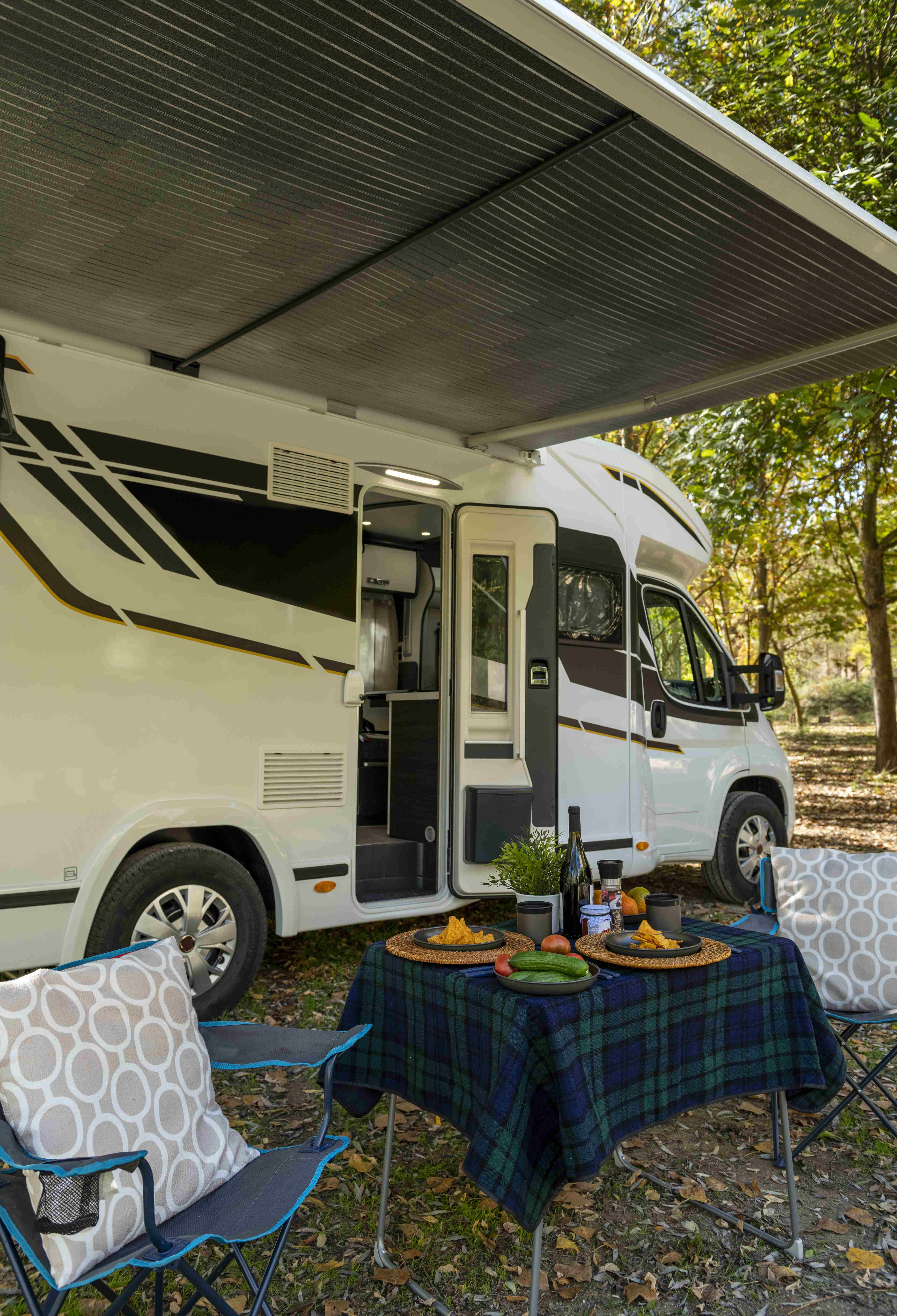 motor-home-with-table-chairs-set-up-outside-vehicle-ready-eating-drinking